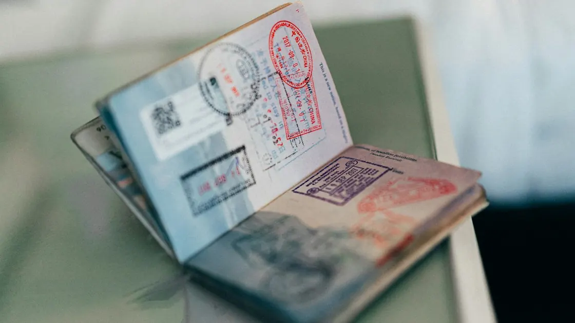 A passport open on a page of travel stamps