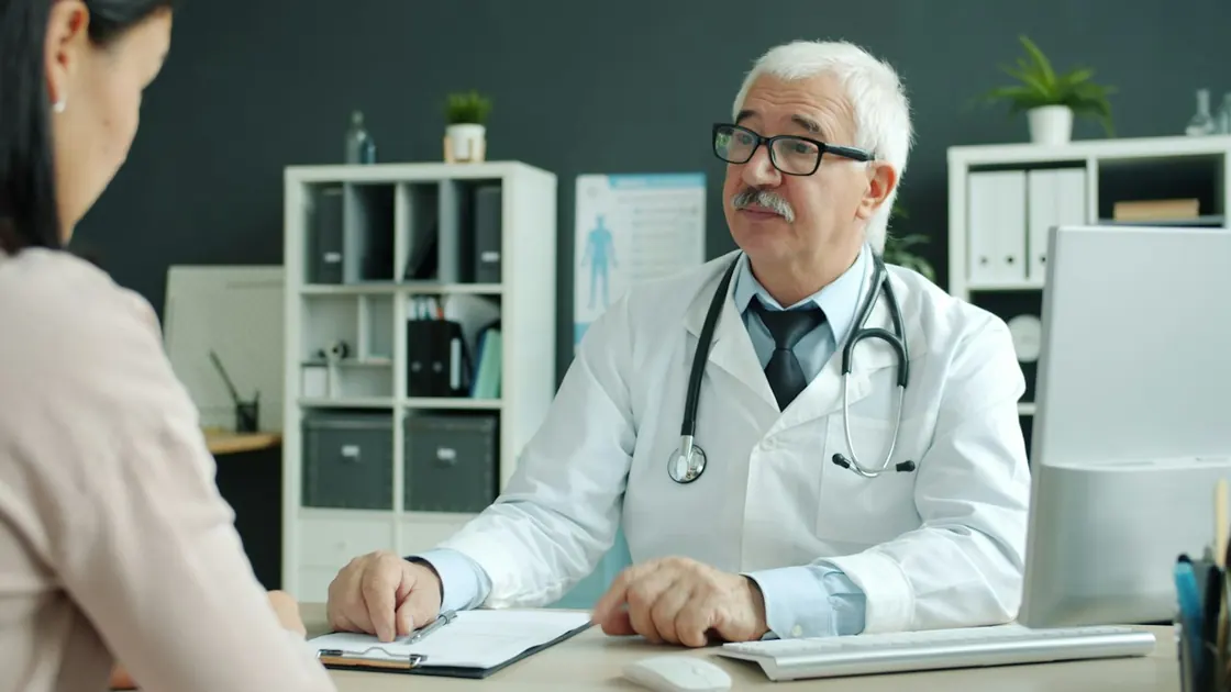 A physician talking with a patient in a clinic office