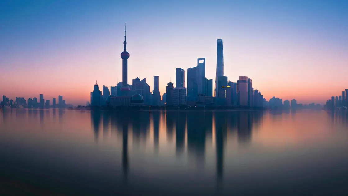 The Shanghai skyline silhouetted across the river at dusk
